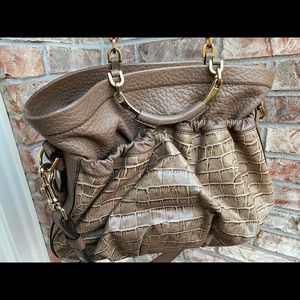Tanned leather; worn  2 times only ;Has plenty of pockets; practical and chic.